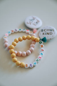 SCHULKIND ARMBAND - BUNT, LASELU